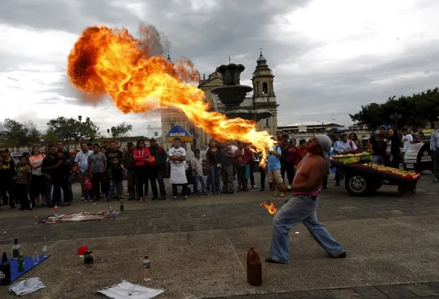 A street artist performs a fire performance in downtown Guatemala City, September 5, 2015. (Photo by Jorge Dan Lopez/Reuters)