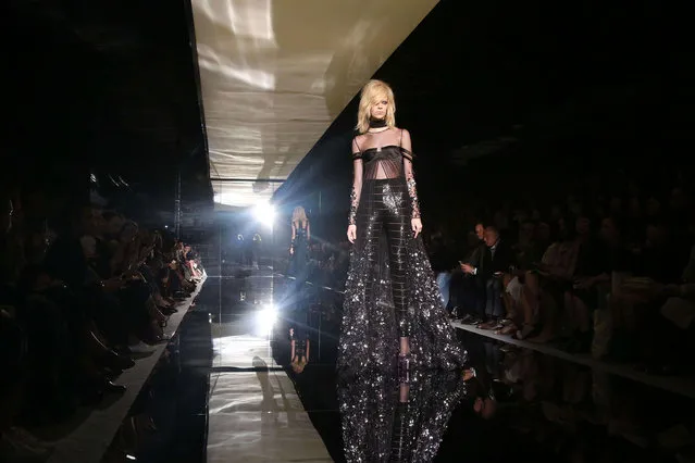 A model wears an outfit by designer Tom Ford for the Spring/Summer 2015 show during London Fashion Week, at Vincent Square in central London, Monday, September 15, 2014. (Photo by Joel Ryan/Invision/AP Photo)