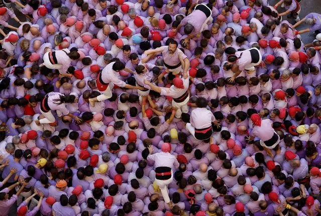 Colla Jove Xiquets de Tarragona start to form a human tower called “castell” during a biannual human tower competition in Tarragona, Spain on October 2, 2022. (Photo by Albert Gea/Reuters)