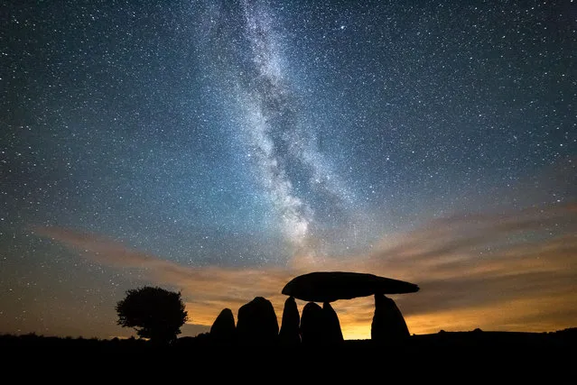 The Milky Way streaks over the Neolithic Pentre Ifan burial chamber in Wales, UK on August 7, 2016. (Photo by Drew Buckley/Rex Features/Shutterstock)