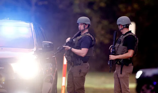 Law enforcement stand at the entrance to Neuse River Greenway Trail parking at Abington Lane following a shooting in Raleigh, N.C., Thursday, October 13, 2022. (Photo by Ethan Hyman/The News & Observer via AP Photo)