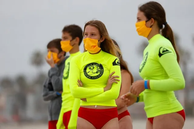 Participants on the beach wear masks as San Diego's Junior Lifeguard Program officially reopens with new protocols in place to comply with county health guidelines in San Diego, California, June 15, 2020. (Photo by Mike Blake/Reuters)