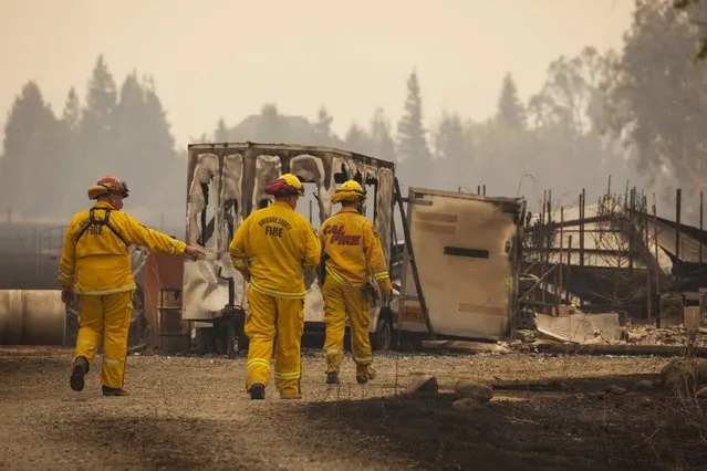 Firefighters survey a destroyed home at the so-called Valley Fire near Middleton, California September 14, 2015. (Photo by David Ryder/Reuters)