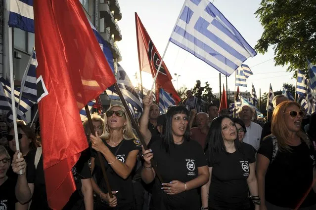Far-right Golden Dawn party supporters hold Greek national flags and party flags during the main pre-election rally outside the party's headquarters in Athens, Greece, September 16, 2015. The outcome of Sunday's Greek national election looks more uncertain than ever after the country's two dominant politicians ruled out working with each other and apparently failed to sway undecided voters in a final televised debate. (Photo by Michalis Karagiannis/Reuters)