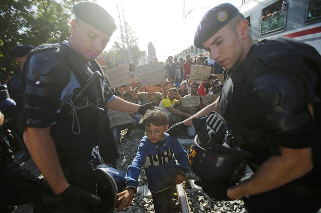 Migrants protest at the Tovarnik railway station, Croatia September 18, 2015. Migrants continued to stream through fields from Serbia into the European Union on Friday, undeterred by Croatia's closure of almost all road crossings after an influx of more than 11,000. Helpless to stem the flow, Croatian police rounded them up at the Tovarnik on the Croatian side of the border, where several thousand had spent the night under open skies. Some kept travelling, and reached Slovenia overnight. (Photo by Antonio Bronic/Reuters)