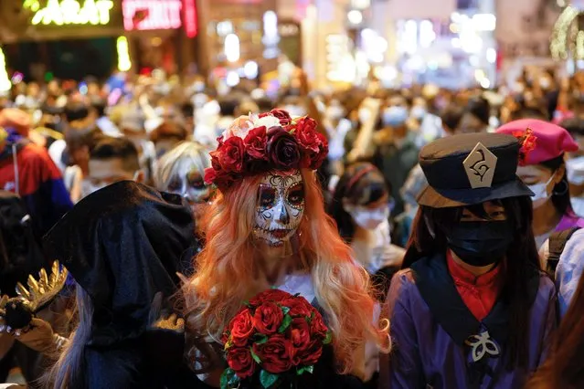 People wear costumes celebrating Halloween at Lan Kwai Fong in Hong Kong, China on October 31, 2022. (Photo by Tyrone Siu/Reuters)