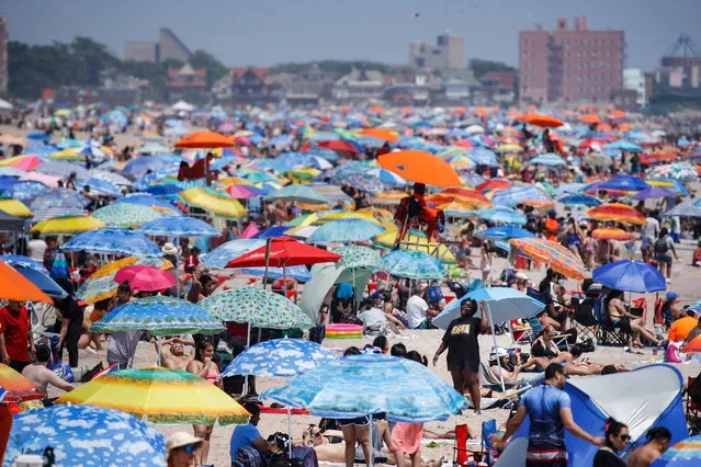 Revelers enjoy the beach at Coney Island, Saturday, July 4, 2020, in the Brooklyn borough of New York. (Photo by John Minchillo/AP Photo)