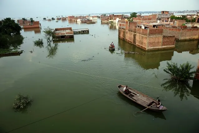Flood affected people move to safer place in Allahabad, India, August 25, 2016. Heavy monsoon rains have ended two successive drought years in India with the Ganges River and its tributaries rising above the danger level, triggering evacuation of hundreds of thousands of people from flooded homes in north and eastern India. (Photo by Rajesh Kumar Singh/AP Photo)
