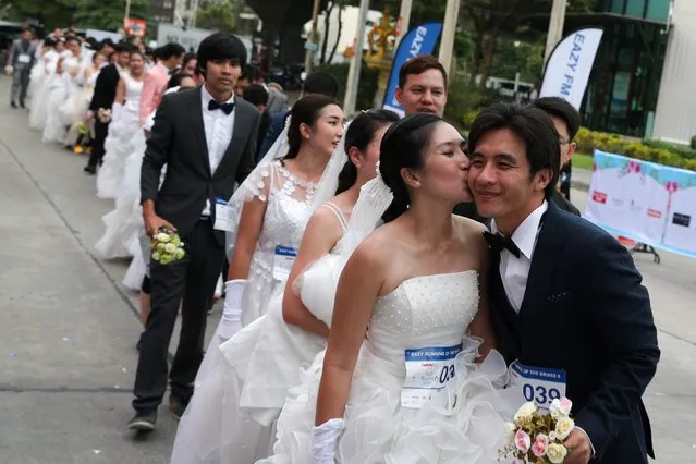 Couples line up before the event during the “Running of the Brides” race, in Bangkok, Thailand, December 2, 2017. (Photo by Athit Perawongmetha/Reuters)