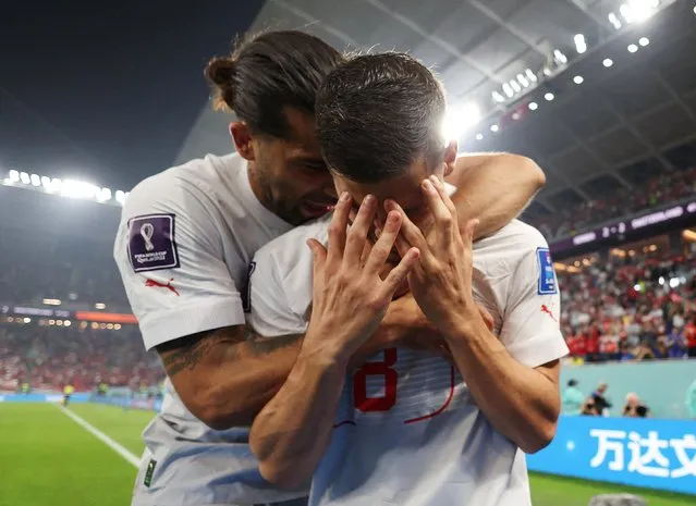 Remo Freuler #8 of Switzerland celebrates with team mate Ricardo Rodriguez #13 after scoring his team's third goal during the FIFA World Cup Qatar 2022 Group G match between Serbia and Switzerland at Stadium 974 on December 2, 2022 in Doha, Qatar. (Photo by Suhaib Salem/Reuters)