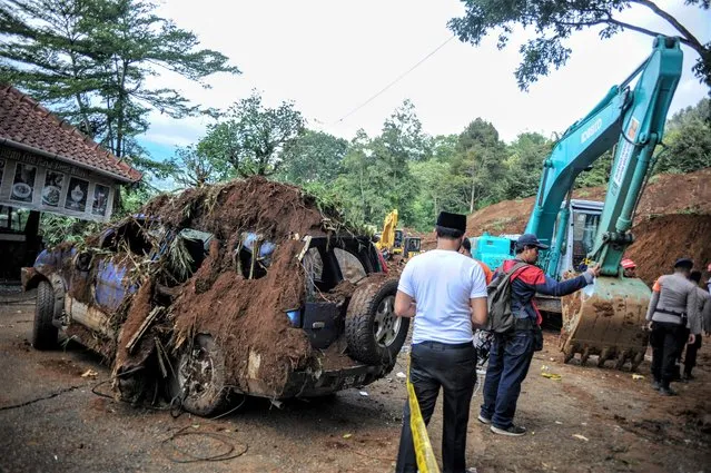 A damaged car is seen on the site of a landslide following earthquake hit in Cianjur, West Java province, Indonesia on November 22, 2022. (Photo by Raisan Al Farisi/Antara Foto)