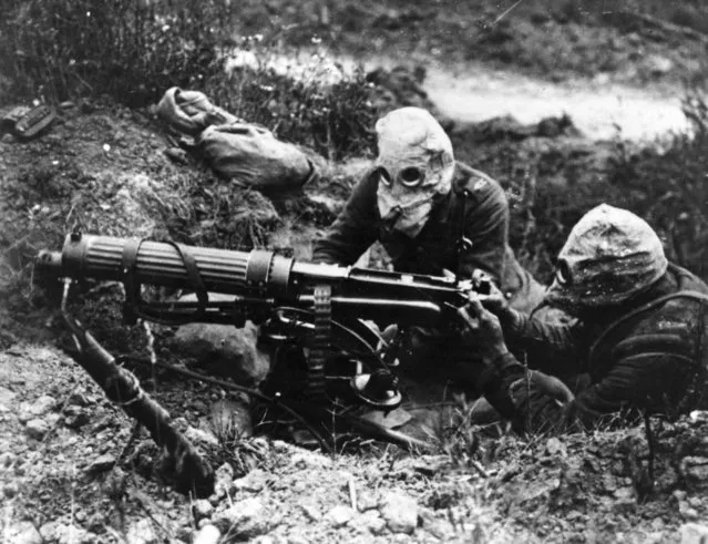 Gas-masked men of the British Machine Gun Corps with a Vickers machine gun during the first battle of the Somme, 1916. (Photo by General Photographic Agency/Getty Images)