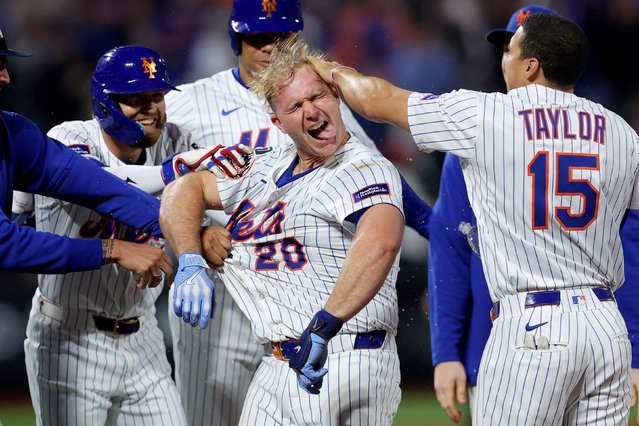 New York Mets slugger Pete Alonso is congratulated by teammates after hitting a game-winning sacrifice fly against Pittsburgh on Monday, May 12, 2025. (Photo by Brad Penner/Imagn Images via Reuters)