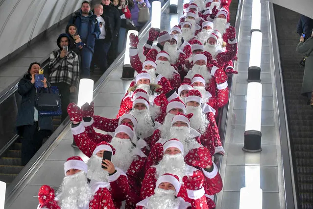 People dressed as Ded Moroz, Grandfather Frost, the Russian Santa Claus, attend an annual flash mob in Moscow's Metro (Subway) in Moscow, Russia, Friday, December 30, 2022. (Photo by Sergei Kiselev, Moscow News Agency photo via AP Photo)