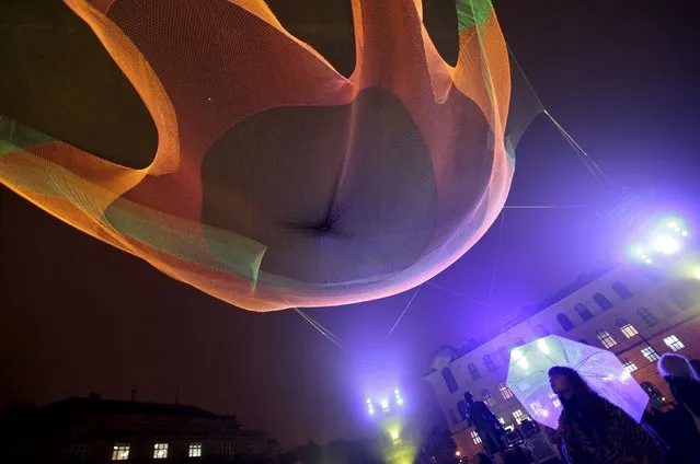 A woman looks at the installation "1.26" during the Signal light festival in Prague, Czech Republic, October 15, 2015. (Photo by David W. Cerny/Reuters)