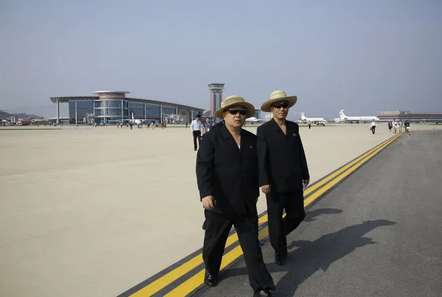 North Korean men walk on the tarmac of the newly renovated Kalma Airport on Saturday, September 24, 2016, in Wonsan, North Korea. (Photo by Wong Maye-E/AP Photo)
