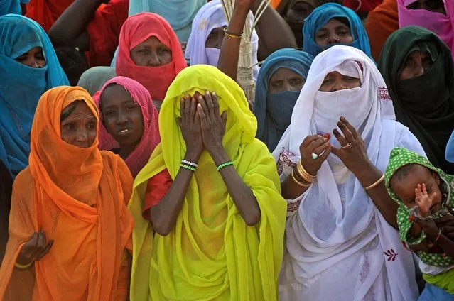Sudanese attend the annual celebration of al-Sharifa Mariam al-Mirghani, an influential Sufi figure known as the “Mother of the Poor” within the Beja community of eastern Sudan, in Sinkat around 120 kilometres from Port Sudan on January 26, 2023. (Photo by Ibrahim Ishaq/AFP Photo)