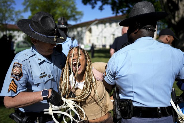 Georgia State Patrol officers detain a demonstrator on the campus of Emory University during a pro-Palestinian demonstration, Thursday, April 25, 2024, in Atlanta. (Photo by Mike Stewart/AP Photo)