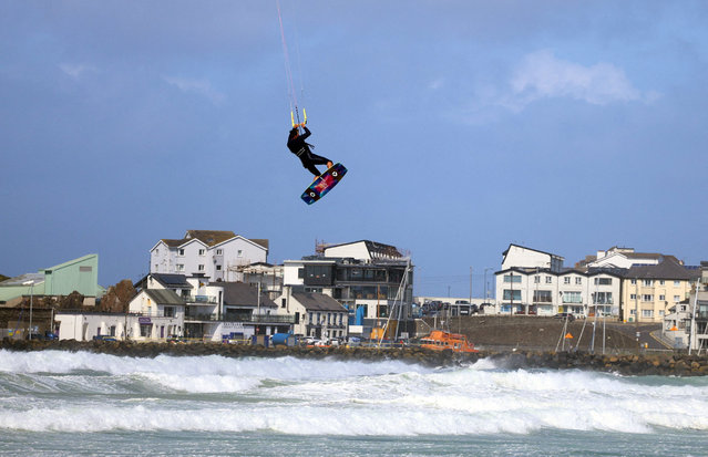 A man kite surfs during Storm Floris on the north coast of Northern Ireland, Portrush, on August 4, 2025. (Photo by Cathal McNaughton/Reuters)