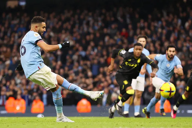 Riyad Mahrez of Manchester City scores their sides third goal from the penalty spot during the Premier League match between Manchester City and Aston Villa at Etihad Stadium on February 12, 2023 in Manchester, England. (Photo by Ryan Pierse/Getty Images)