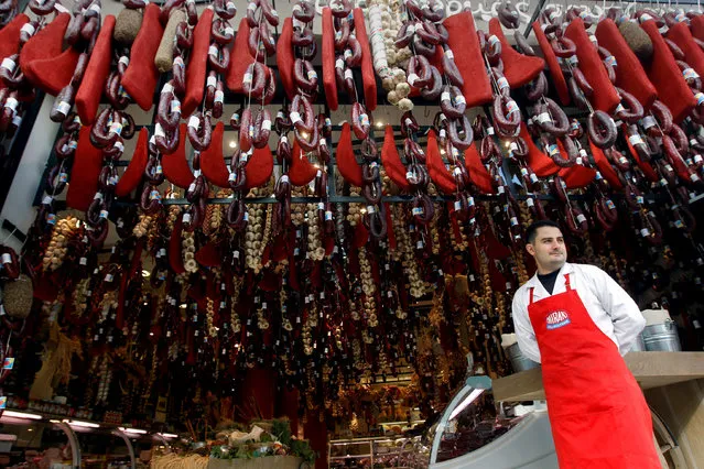 A grocer stands outside his shop in Athens, Greece November 8, 2011. (Photo by John Kolesidis/Reuters)
