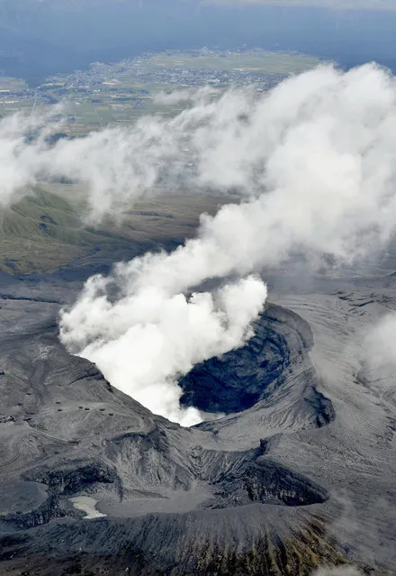 In this aerial view, plumes of white smoke rise from Mount Aso Nakadake Crater in Kumamoto Prefecture, southern Japan, Saturday morning, October 8, 2016 following eruptions earlier in the day. Mount Aso has sent huge plumes of gray smoke as high as 11 kilometers (6.8 miles) into the air in one of the volcano's biggest explosions in years. (Photo by Hiroko Harima/Kyodo News via AP Photo)