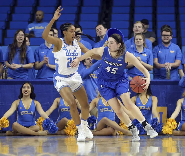 Crieghton forward Audrey Faber (45) drives as UCLA forward Monique Billings (25) defends in the first half of a second-round game in the NCAA women's college basketball tournament in Los Angeles, Monday, March 19, 2018. (Photo by Reed Saxon/AP Photo)