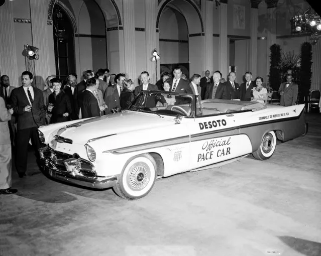 The official Pace Car for the Memorial Day Indianapolis Motor Speedway 500-mile race is unveiled at the Hotel Waldorf-Astoria in New York City, January 11, 1956.  The automobile is a gold and white DeSoto Special Convertible. (Photo by AP Photo)