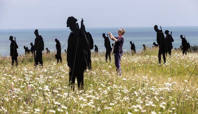 Silhouettes representing soldiers who lost their lives during D-day stand in a meadow next to the British Normandy Memorial near Ver-sur-Mer in Normandy on June 3, 2024. The display, called Standing with giants, has 1,475 figures, the number of   servicemen who died under British command on D-day. (Photo by Richard Pohle/The Times)