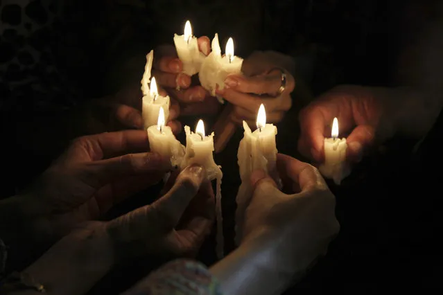 People light candles to pay tribute to the victims of an overnight attack on the Quetta Police Training Academy during a vigil in Lahore, Pakistan, Tuesday, October 25, 2016. Militants wearing suicide vests stormed a Pakistani police academy in the southwestern city of Quetta overnight, killing dozens of people, mostly police cadets and recruits, and waging a ferocious gun battle with troops that lasted into early hours Tuesday. (Photo by K.M. Chaudary/AP Photo)