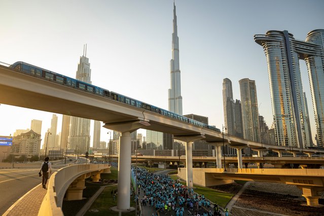 Runners take part in the “Dubai Run 2025” as part of the 9th Edition of Dubai Fitness Challenge, in Dubai on November 23, 2025. (Photo by Fadel Senna/AFP Photo)