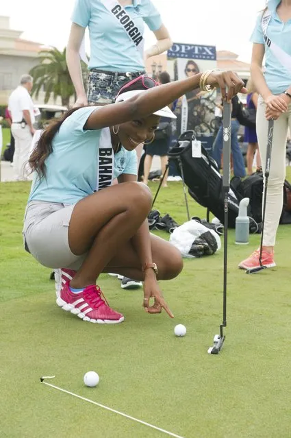 Tomii Culmer, Miss Bahamas 2014, practices for a putting contest at the 63rd annual Miss Universe Pageant in Miami, Florida in this January 12, 2015 handout photo provided by Miss Universe Organization. (Photo by Reuters/Miss Universe Organization)