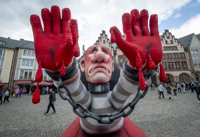 A figure depicting Russian President Vladimir Putin is placed in front of the town hall ahead of a demonstration of Ukrainians in Frankfurt, Germany, Friday, October 11, 2024. (Photo by Michael Probst/AP Photo)