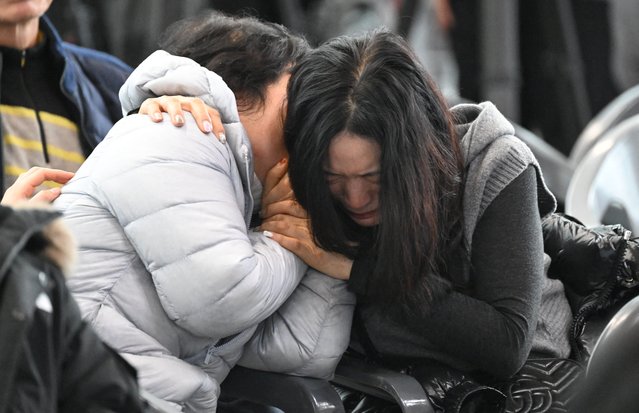 Relatives of passengers of a Jeju Air Boeing 737-800 series aircraft react near a make-shift shelter at Muan International Airport in Muan, some 288 kilometres southwest of Seoul on December 30, 2024. The Boeing 737-800 was carrying 181 people from Thailand to South Korea when it crashed on arrival on December 29, killing everyone aboard -- save two flight attendants pulled from the twisted wreckage of the worst aviation disaster on South Korean soil. (Photo by Jung Yeon-Je/AFP Photo)