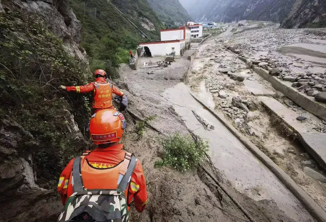In this photo released by China's Xinhua News Agency, rescuers work at a landslide site in Miansi Township of Wenchuan County in southwestern China's Sichuan Province, Tuesday, June 27, 2023. Several people were found dead and others remained missing after landslides hit a county in China's southwestern Sichuan province on Tuesday, leading to authorities evacuating more than 900 people. (Photo by Xinhua via AP Photo)