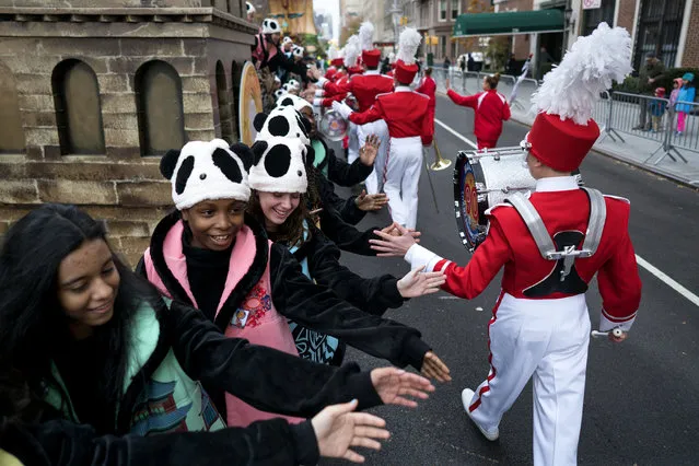 Participants greet others as they await the start of the Macy's Thanksgiving Day Parade in New York, Thursday, November 24, 2016. (Photo by Craig Ruttle/AP Photo)