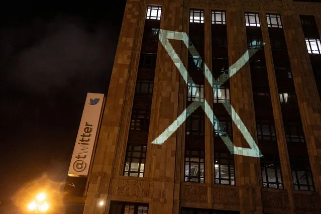 Twitter's new logo is seen projected on the corporate headquarters building in downtown San Francisco, California, U.S. July 23, 2023. (Photo by Carlos Barria/Reuters)