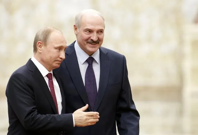 Belarus' President Alexander Lukashenko (back) and his Russian counterpart Vladimir Putin walk during peace talks in Minsk, February 11, 2015. (Photo by Vasily Fedosenko/Reuters)