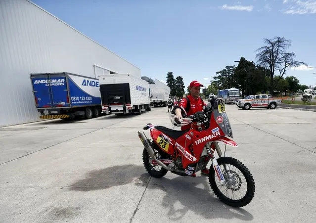 Gerard Farres of Spain pushes his KTM motorcycle as he leaves the technical verification area ahead of the Dakar Rally 2016 in Buenos Aires, Argentina, January 1, 2016. (Photo by Marcos Brindicci/Reuters)