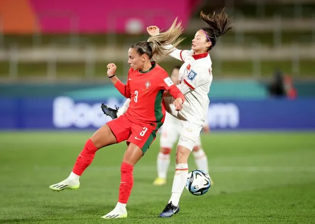 Portugal's defender #03 Lucia Alves and Vietnam's defender #05 Thi Loan Hoang fight for the ball during the Australia and New Zealand 2023 FIFA Women's World Cup Group E football match between Portugal and Vietnam at Waikato Stadium in Hamilton on July 27, 2023. (Photo by David Rowland/Reuters)