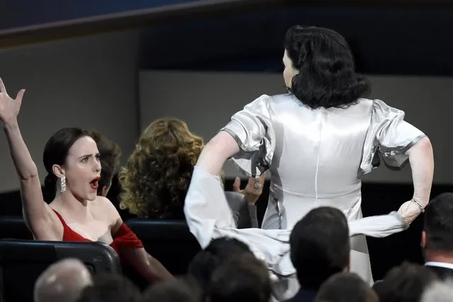 Alex Borstein takes off a top layer of her dress before appearing on stage to accept the award for outstanding supporting actress in a comedy series for “The Marvelous Mrs. Maisel” at the 70th Primetime Emmy Awards on Monday, September 17, 2018, at the Microsoft Theater in Los Angeles. Cheering on at left is Rachel Brosnahan. (Photo by Chris Pizzello/Invision/AP Photo)