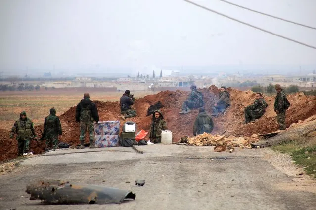 Syrian government forces hold a position in the village of Ain al-Beida in the countryside of Al-Bab in the eastern part of Syrian northern Aleppo province after taking control of the area from Islamist jihadists on January 13, 2016. Eastern parts of Aleppo province are held by the Islamic State jihadist group, and the west is held by opposition groups ranging from US-backed rebels to Al-Nusra. (Photo by George Ourfalian/AFP Photo)