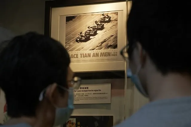 A picture showing a man blocking a line of tanks at the 1989 pro-democracy movement in Beijing is displayed at the “June 4 Memorial Museum” run by pro-democracy activists in Hong Kong on Sunday, May 30, 2021. The museum commemorating the June 4, 1989, crackdown in Beijing reopened Sunday, in advance of this year's anniversary. The museum's organizer usually hosts an annual candlelight vigil, but in the face of a second year of refusal of permission from authorities on COVID-19 concerns, and the imprisonment of others for last year's event, this time, organizers said they would not try again, but keep their museum open til 10 p.m. on June 4. (Photo by Vincent Yu/AP Photo)