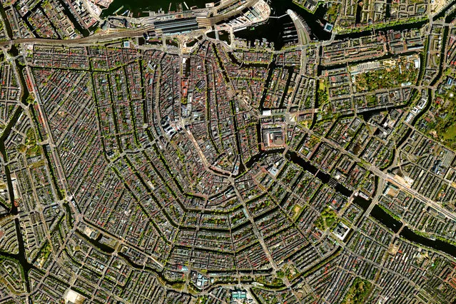 Amsterdam 52°22’15.6”N, 4°53’30.7”E. The canal system of Amsterdam, known as Grachten. In the early 17th century, when immigration was at a peak, a comprehensive plan for the city’s expansion was developed with four concentric half-circles of canals emerging at the main waterfront (seen on the right-hand side of this overview). In the centuries since, the canals have been used for defence, water management, and transport. They remain a hallmark of the city. (Photo by Daily Overview/DigitalGlobe, a Maxar Company)