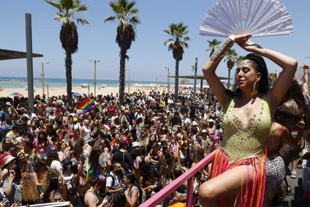 Participants attend the first Tel Aviv pride event since before the Covid-19 pandemic on June 25, 2021 even as officials urged marchers to wear masks amid a surge in infections. Organisers called it the “largest parade of its kind held worldwide since the outbreak of Covid-19”. The last Tel Aviv Pride in 2019 drew a quarter of a million revellers, who danced on colourful floats under rainbow banners in the beachside city. This year's celebration will be more subdued as Israel remains largely closed to tourists due to the coronavirus. (Photo byJack Guez/AFP Photo)