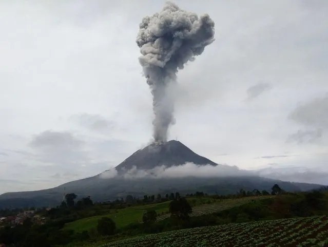 Mount Sinabung spews hot ash and smoke into the sky, seen from Karo, in North Sumatra on May 7, 2021. (Photo by Iksan Gitsu/AFP Photo)