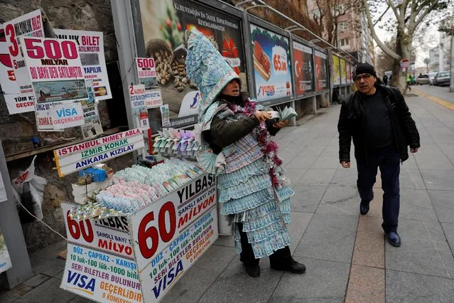 Ali Yedekcioglu, 50, a lottery ticket vendor wearing a dress and a hat made of New Year tickets, sells tickets in a lottery that has 60 million Turkish lira ($17 million) as the highest reward and 348 million Turkish lira ($99 million) as the total reward in Ankara, Turkey, December 27, 2016. (Photo by Umit Bektas/Reuters)