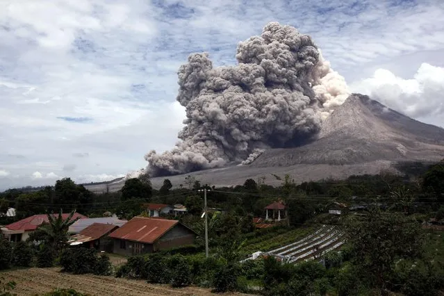 Mount Sinabung releases pyroclastic flows seen from Tiga Serangkai, North Sumatra, Indonesia, Wednesday, April 1, 2015. (Photo by Binsar Bakkara/AP Photo)