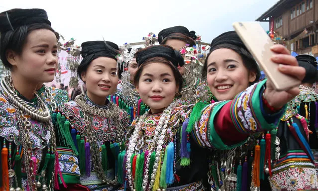 People of the Dong ethnic group take a selfie during a contest of the Dong Nationality Pipa Songs (“Lute Songs”) on January 28, 2016 in Liping County, China. (Photo by ChinaFotoPress/ChinaFotoPress via Getty Images)