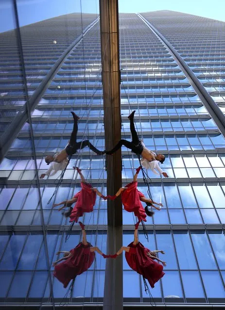 Dancers of the Italian vertical dance company “Il Posto” perform at the base of Japan's tallest building, the Mori JP Tower, in Tokyo, Japan on November 20, 2023. Mori Building Co., Ltd. presented to the media the Azabudai Hills complex prior to its official opening on 24 November 2023. At the center of the Azabudai Hills complex soars the Mori JP Tower, Japan's tallest building reaching 330 meters. The new complex will be able to host 20,000 employees and 3,500 residents and is the largest project undertaken by the urban redevelopment and real estate giant. (Photo by Franck Robichon/EPA/EFE)